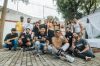 Diverse group of friends having fun and posing for a group photo outdoors in São Paulo.